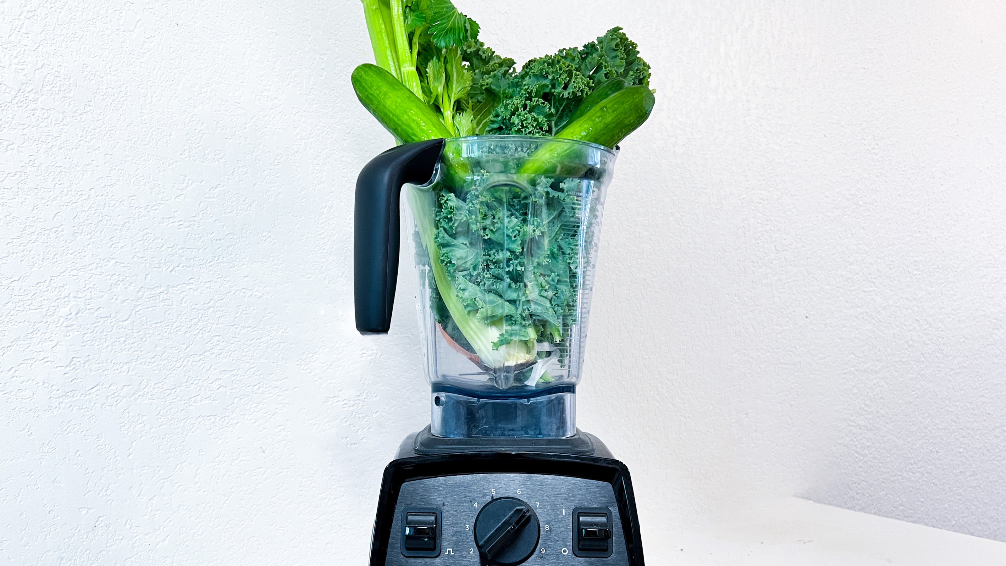 Healthful ingredients in a blender before mixing for a green smoothie recipe