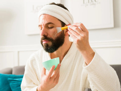 Man applying mask on his face