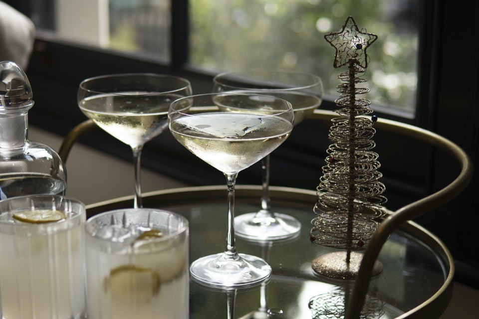 Drinks caddy with cocktails and a bronze display Christmas tree decoration