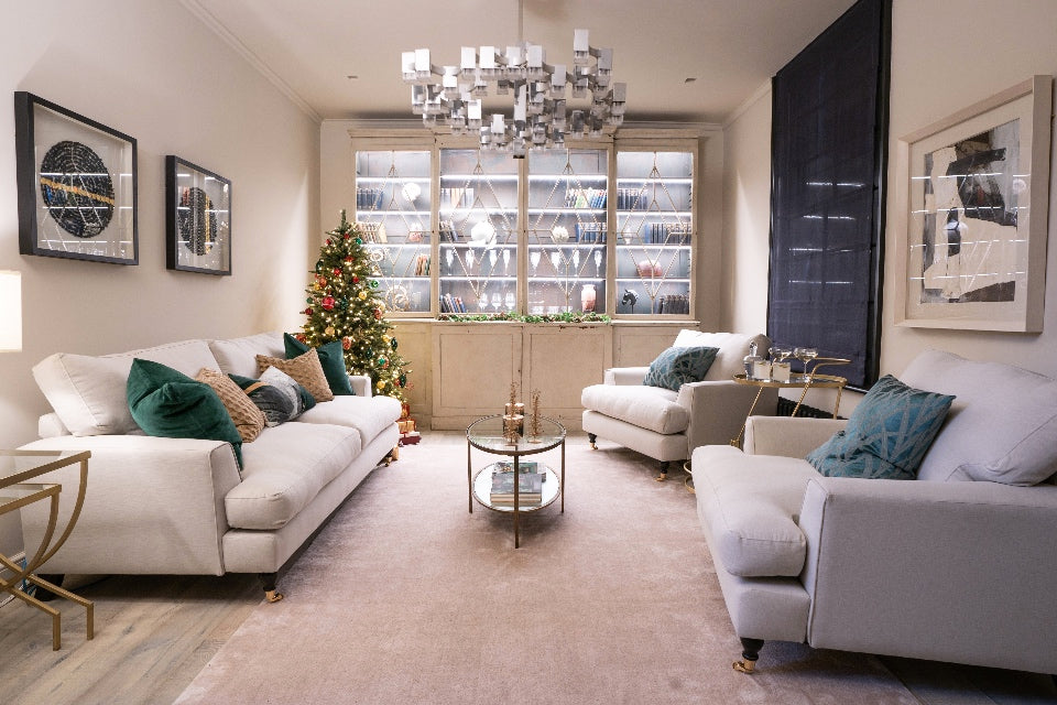 London townhouse reception room with art deco dresser, white sofas and a christmas tree