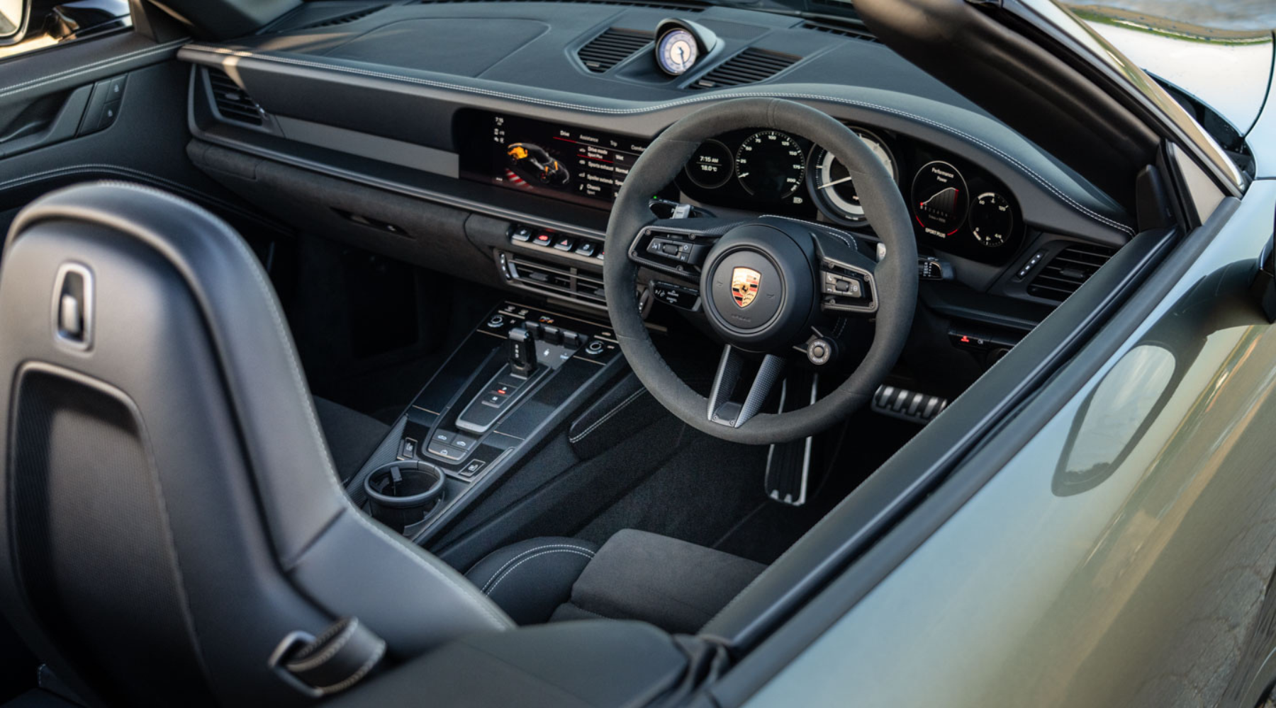 Omaze Million Pound House Draw Marbella Win a Porsche 911 GTS. Black leather interior of the Porsche with steering wheel