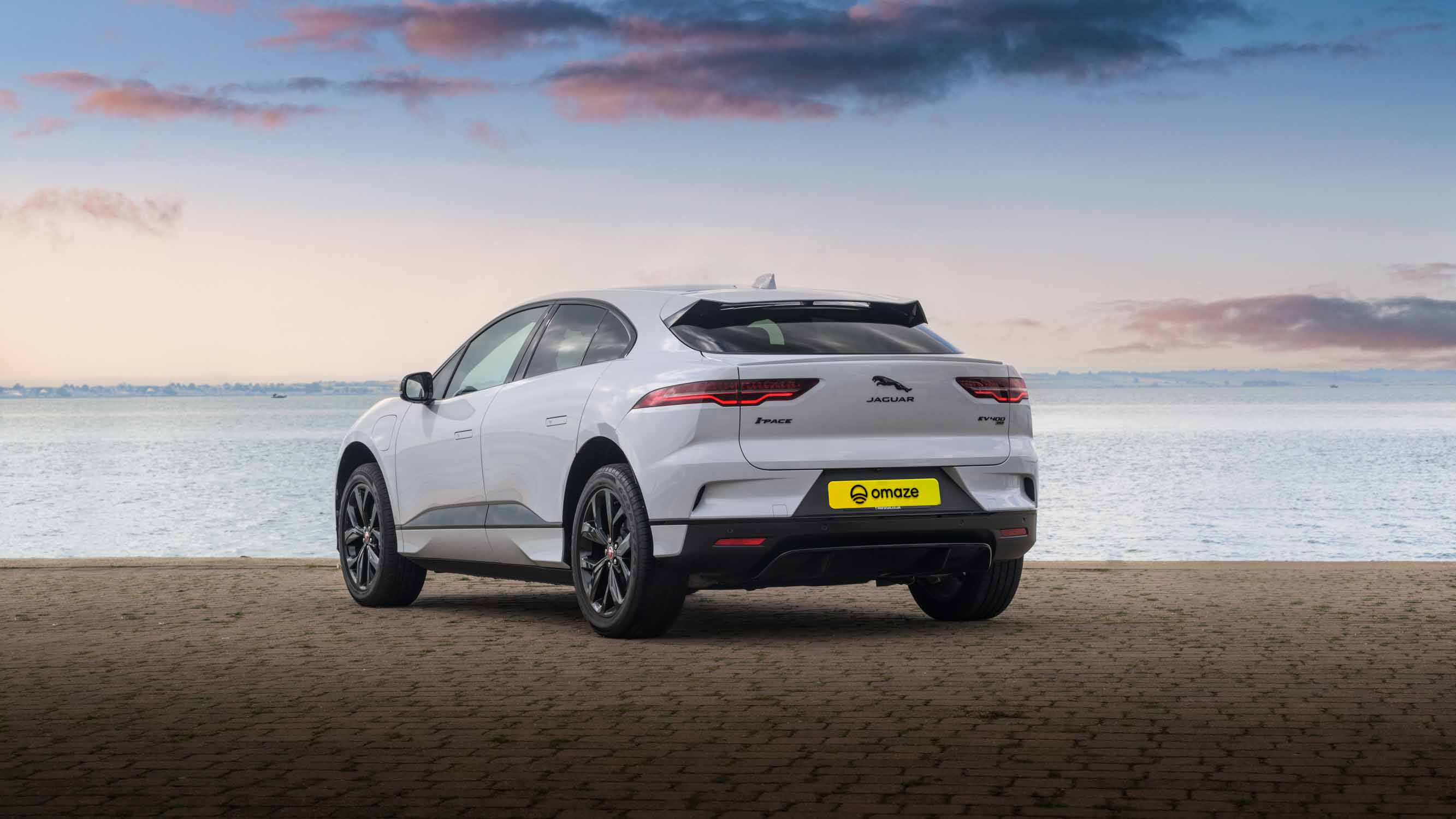 Win a Jaguar I-Pace in the Omaze Marbella Superdraw - Back of the I-Pace against the harbour backdrop