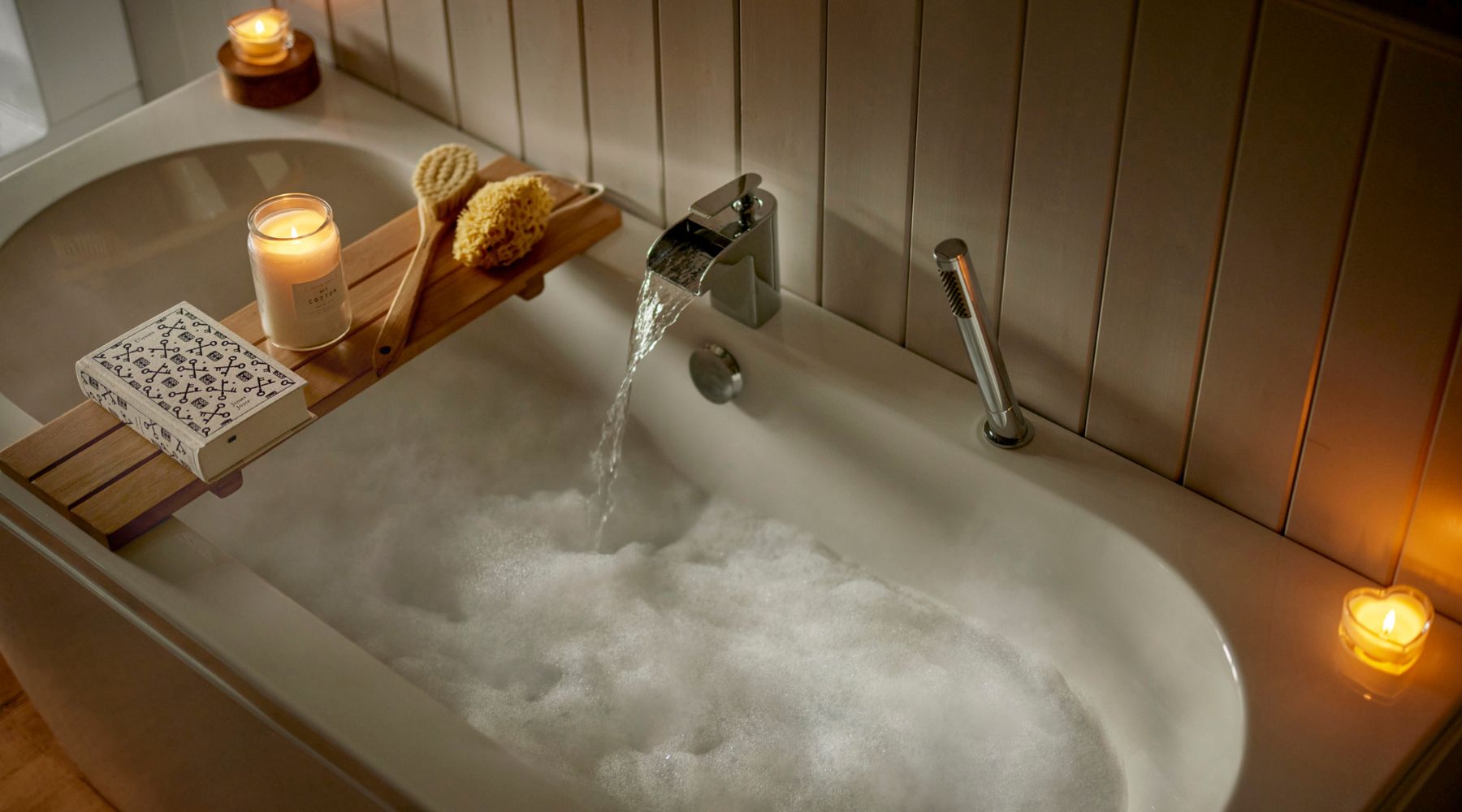 Omaze Million Pound House Lake District  - Bubble bath with candles and wooden rack with book