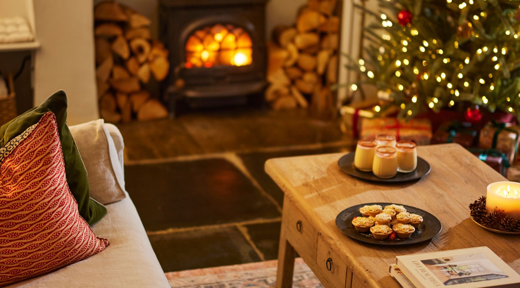 Omaze Million Pound House Lake District  - Glasses of Eggnog on the table by the log burning stove and Chistmas tree  