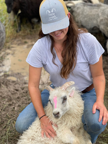 Caroline holding Icelandic lamb to give it a health check