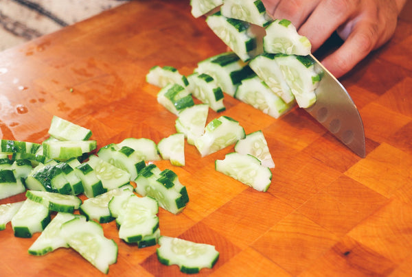 Cucumber being chopped for a fur buddy