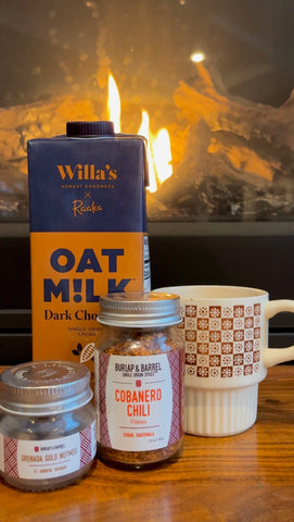 Spicy Chili Mocha with Willa's Dark Chocolate Oat Milk and Burlap & Barrel Cobanero Chili sitting by a lit fireplace