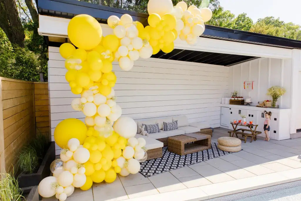 yellow balloon garland on pool cabana