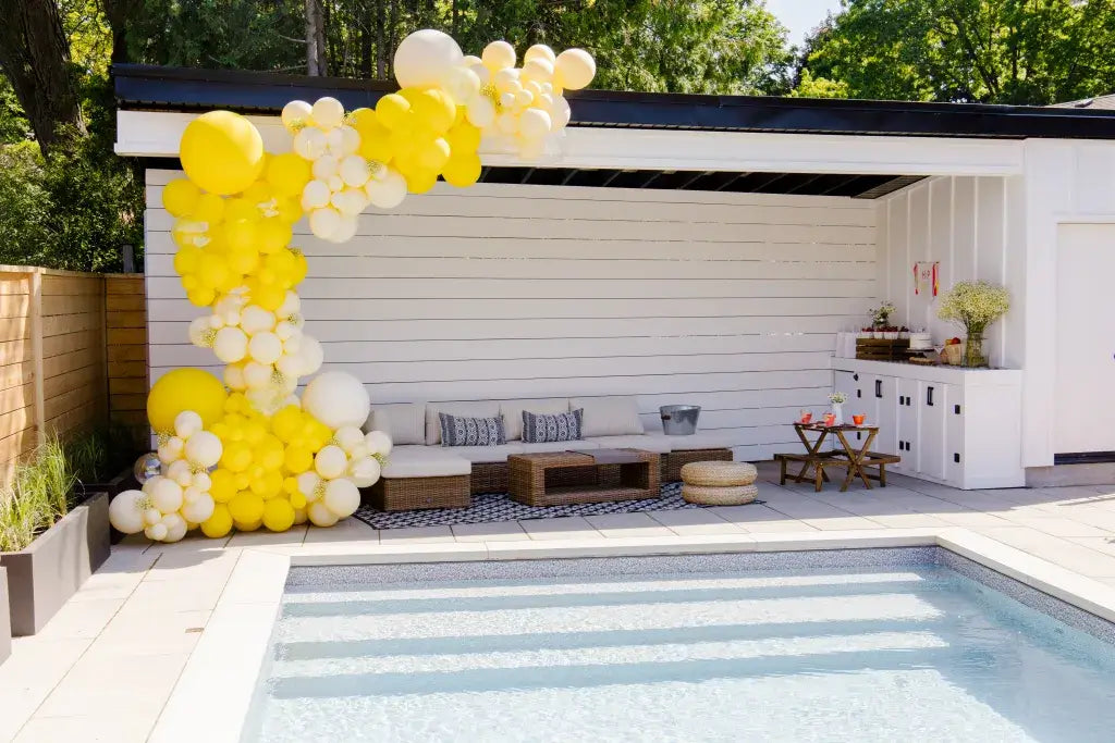 yellow balloon garland on pool cabana