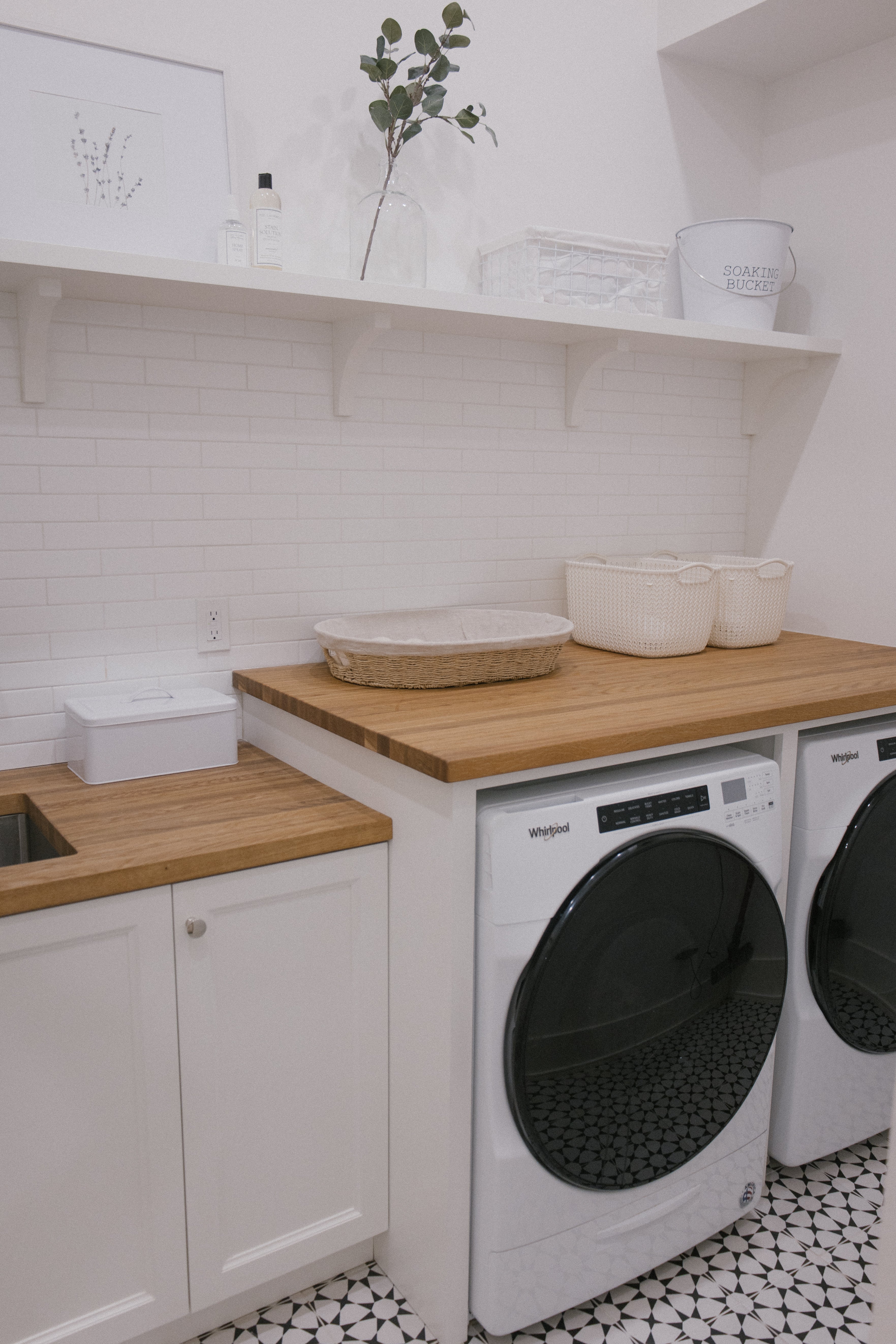 laundry room washer dryer and wood countertop