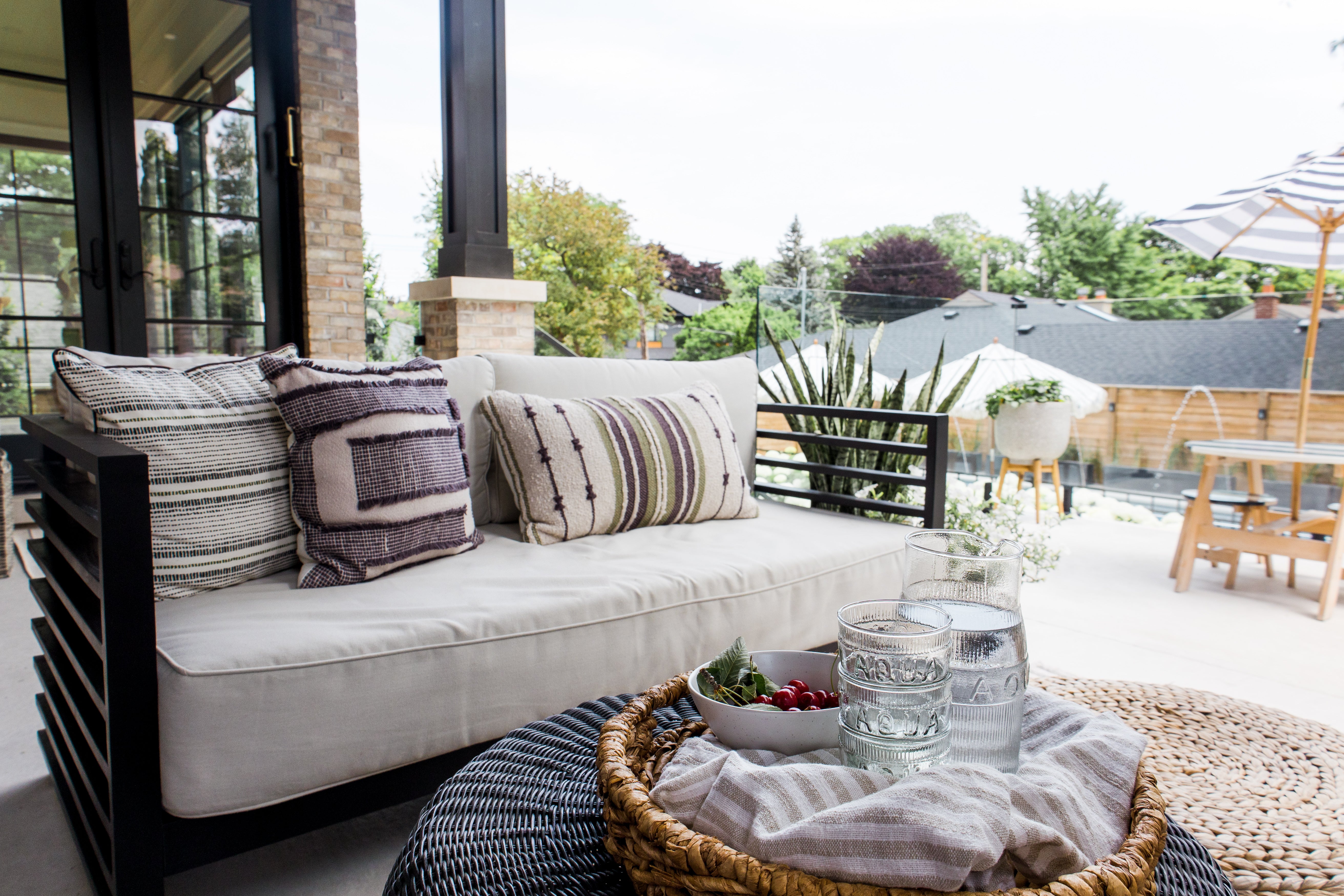 Black slatted sofa with fringe pillows