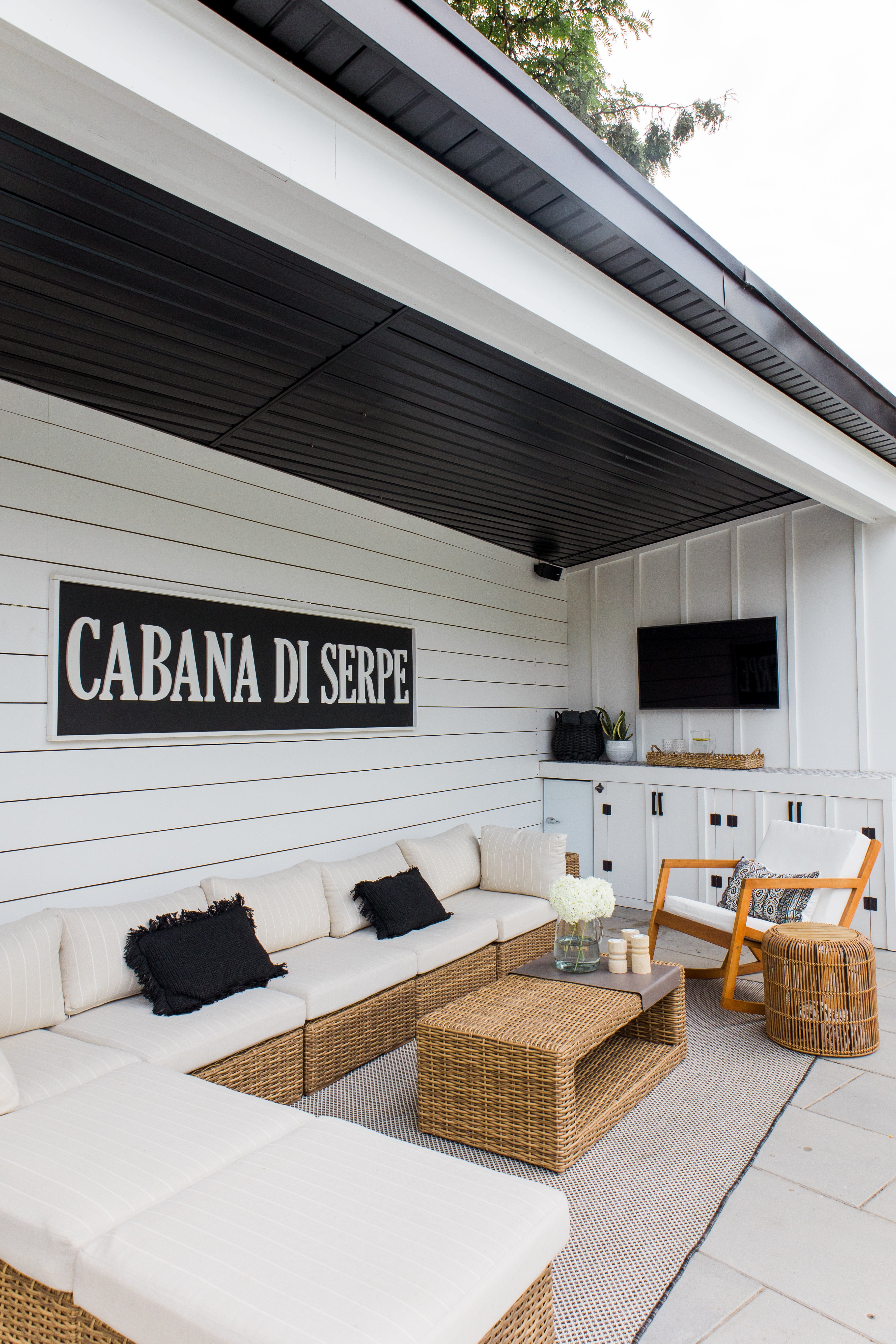 pool cabana with sectional and tv