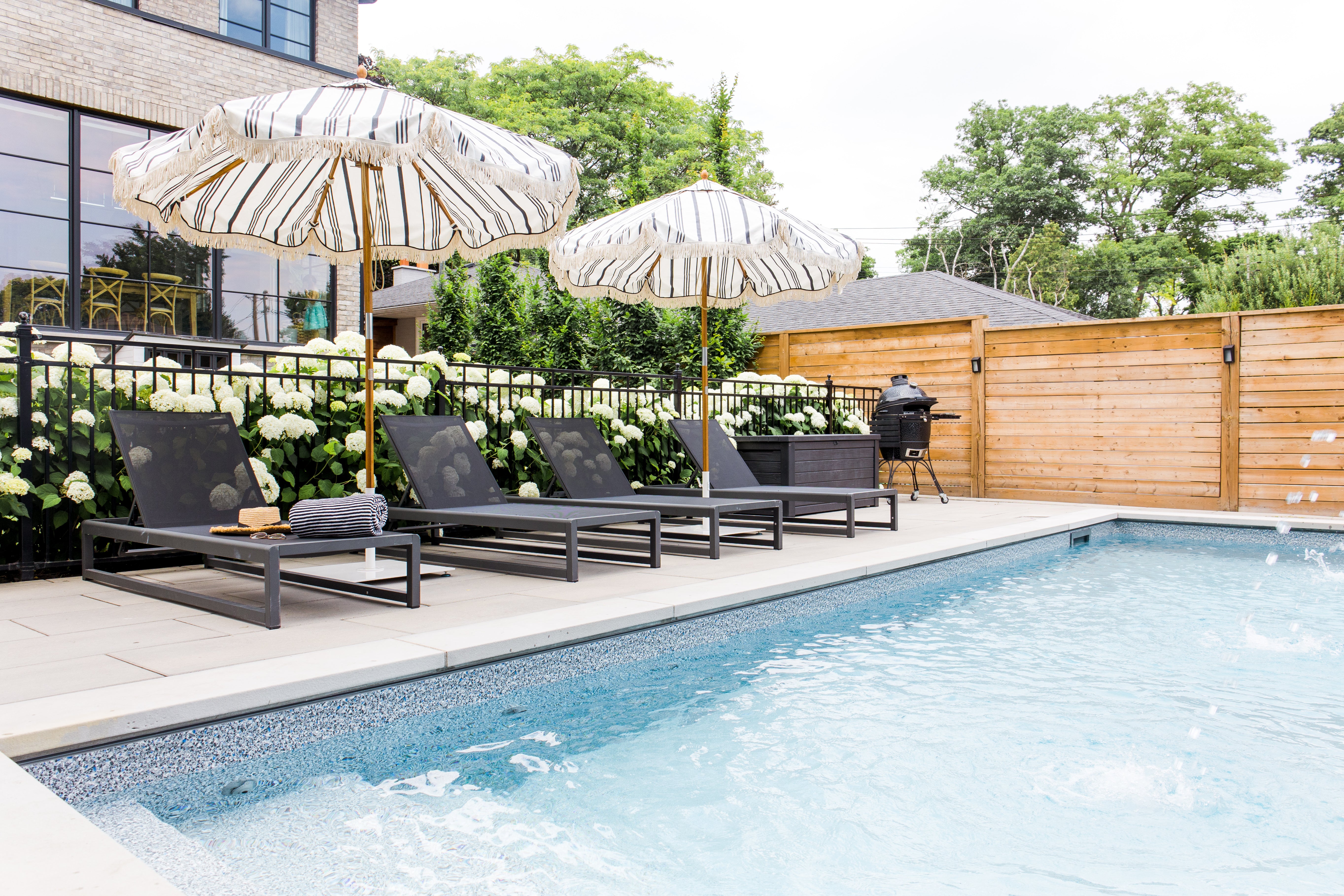 pool with black lounge chairs and umbrellas