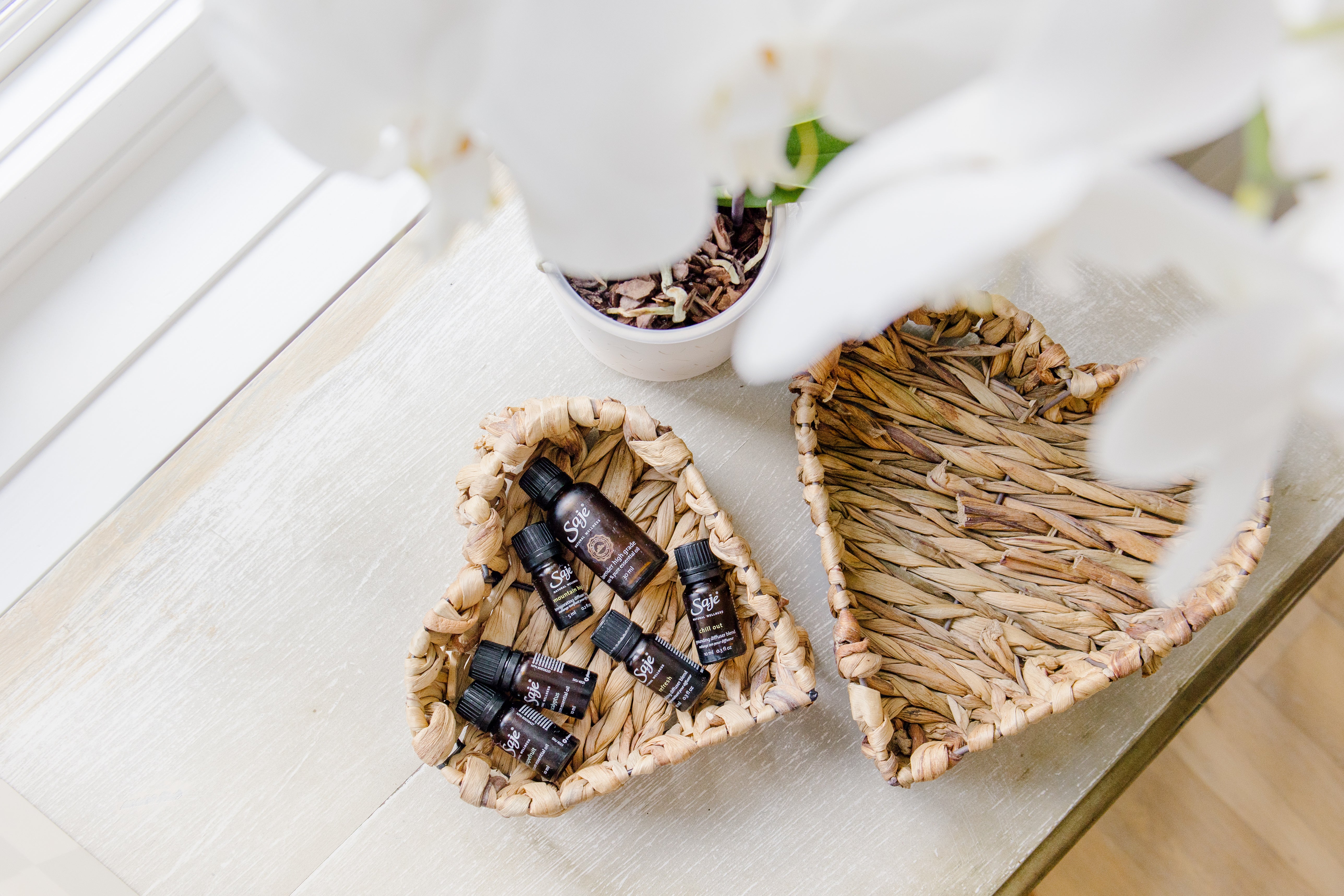 two woven heart baskets filled with essential oils