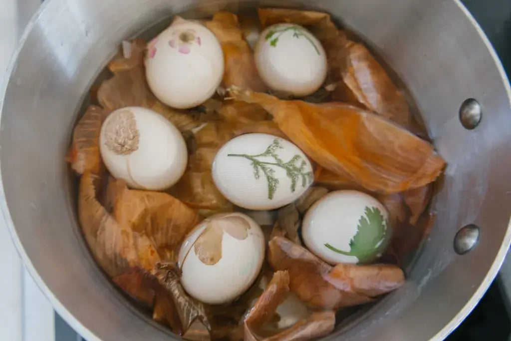 nylon wrapped eggs in pot with onion peels