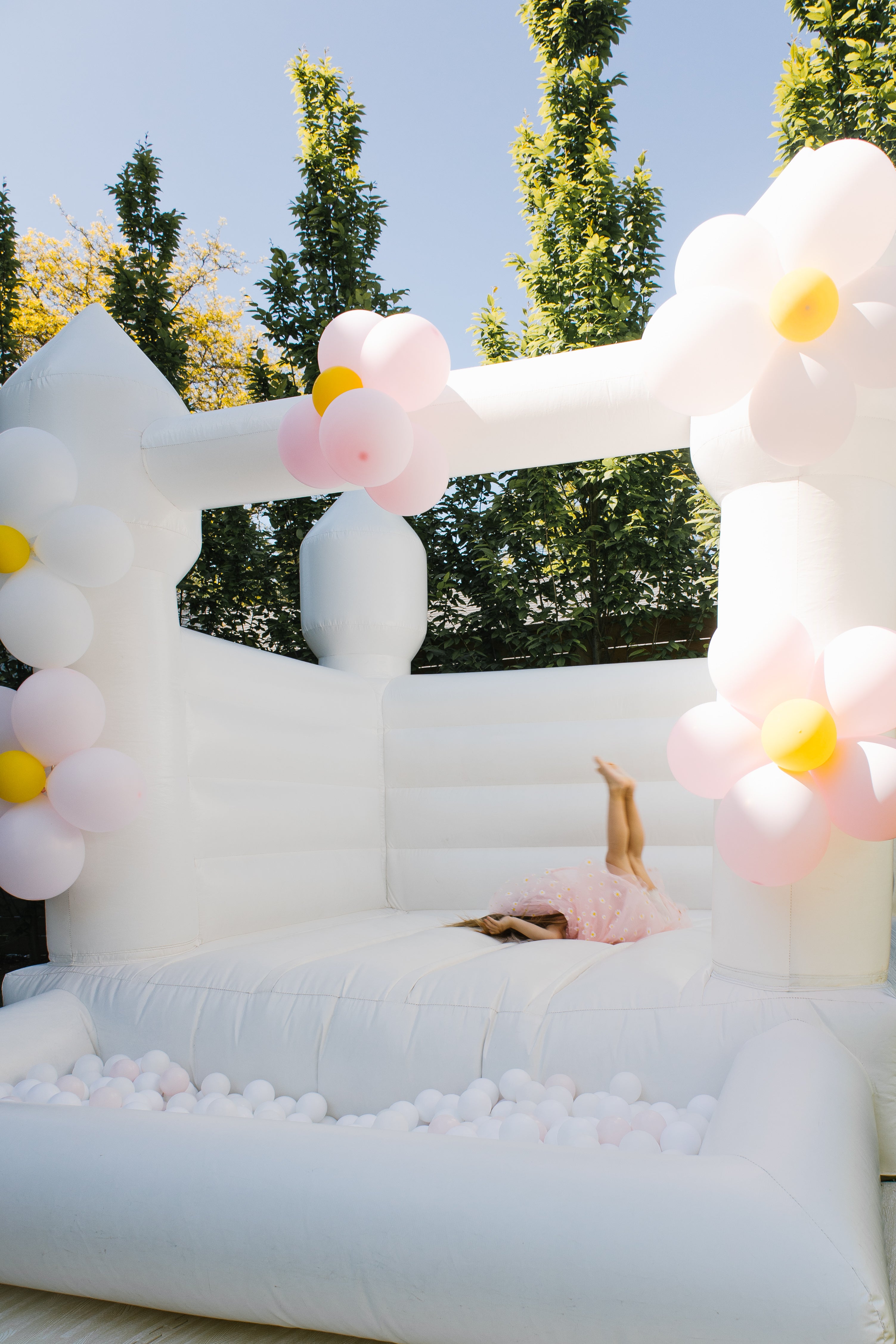 white bouncy castle with flowers