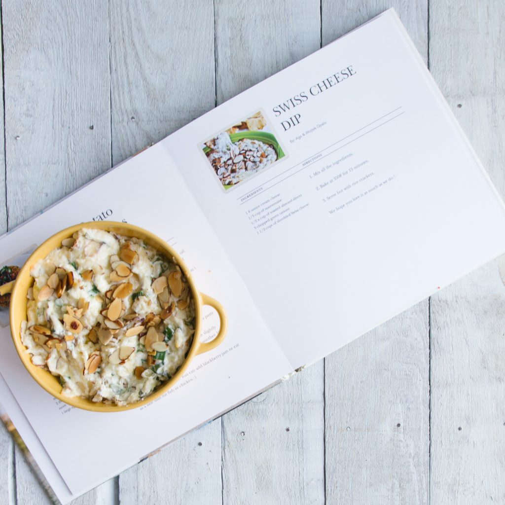 Swiss cheese dip on cookbook with recipe page open