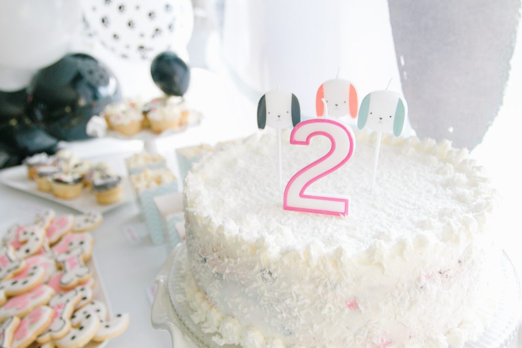 Birthday cake with number 2 candle and dog candles