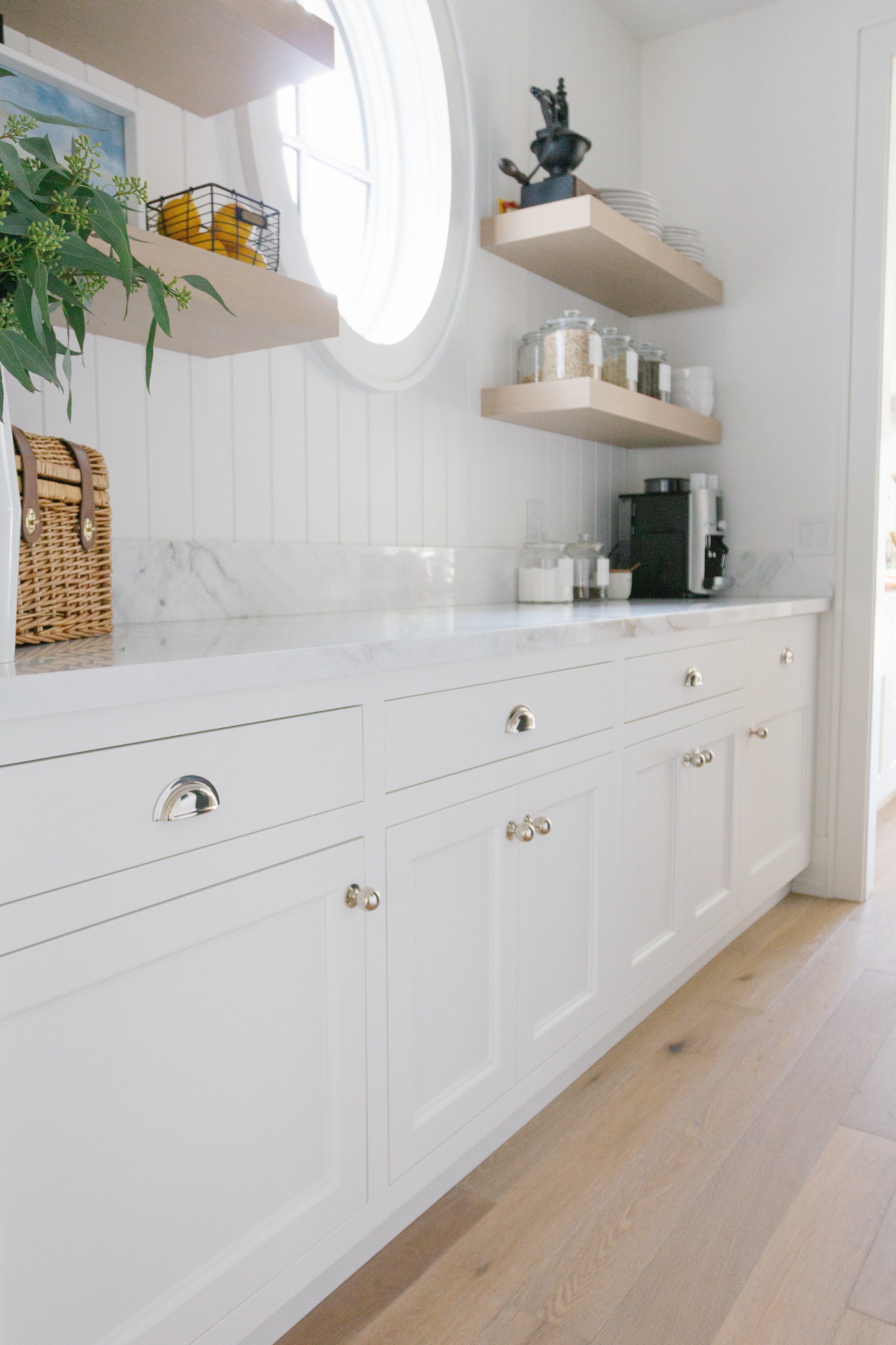 White kitchen with floating shelves