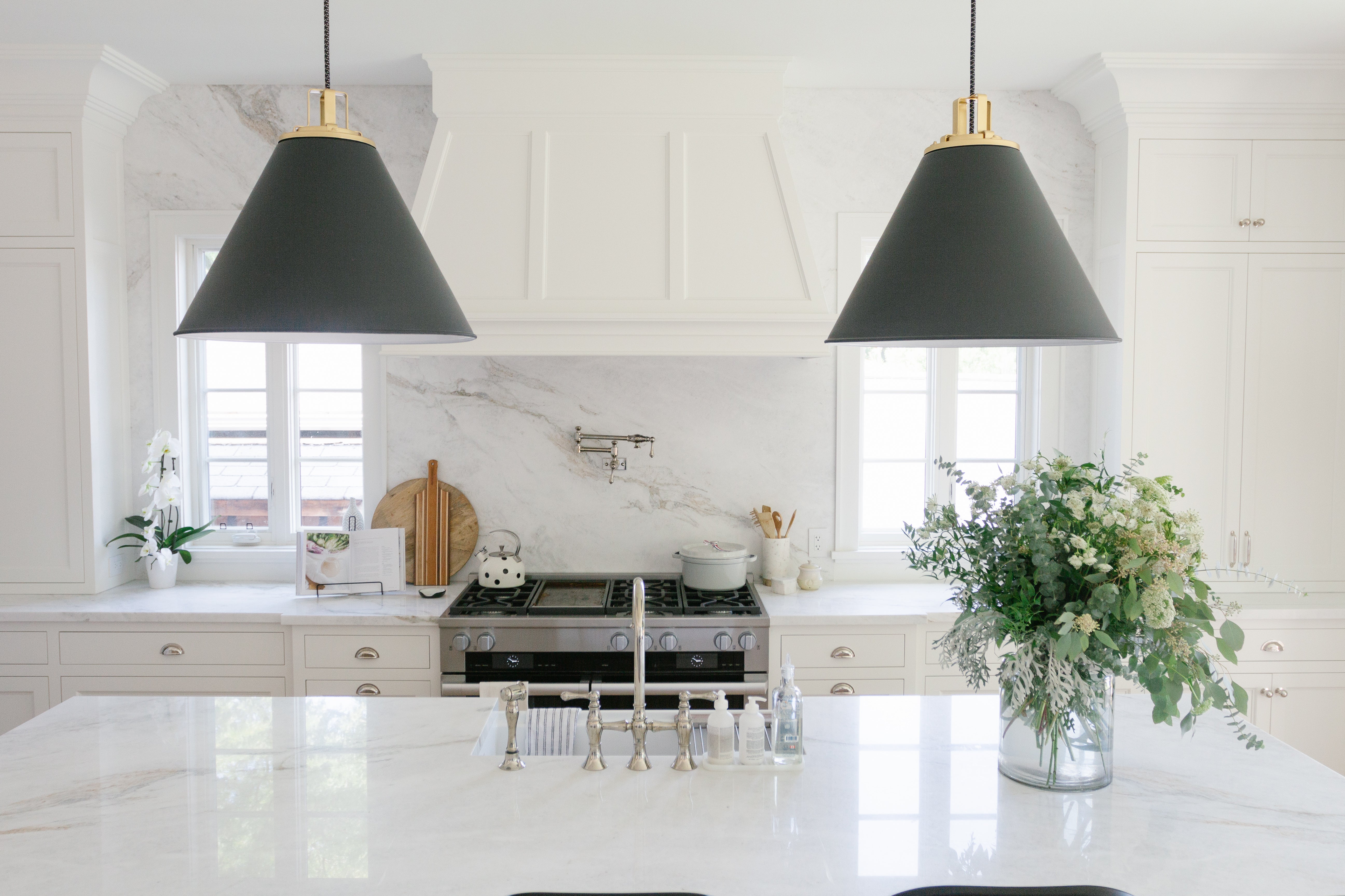 White kitchen with black pendants