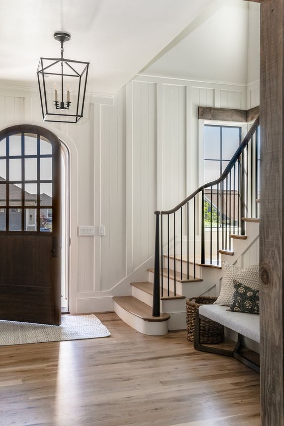 entryway with wall moulding and wood door