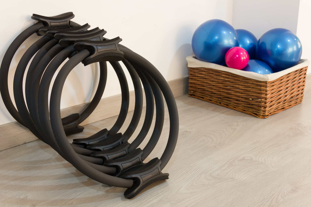 A stack of black Pilates rings ready to be used for exercises.