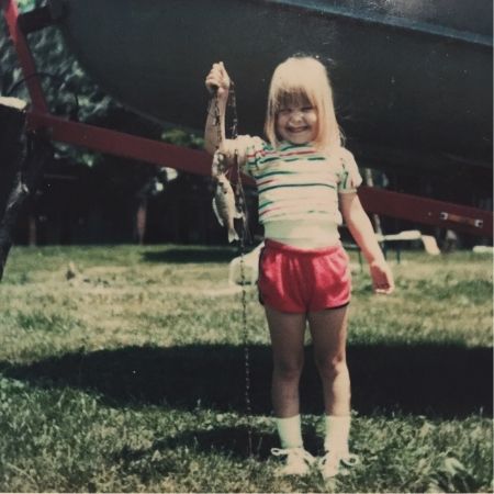 Little Gina proudly holding her fish she caught in front of her dad’s boat.