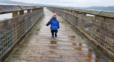 child on boardwalk