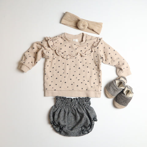 Photo of children's 6-9M clothing; cream and black leopard print sweatshirt with ruffle detail around neck, handmade grey corduroy soft soled shoes, black and white bloomers and a cream ribbed headband with a knot detail