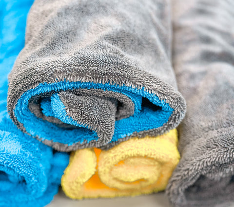 Twister Drying Towels in 4 Colors Stacked up and rolled up