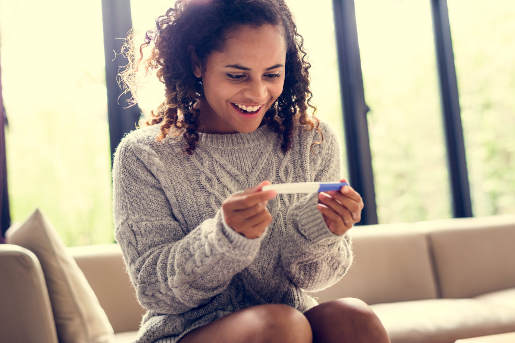 Happy woman with a pregnancy test