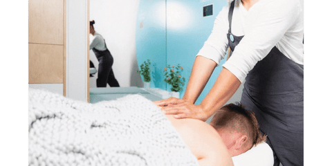 woman giving a massage to a man lying down on table