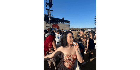 girl using heat not burn device at festival