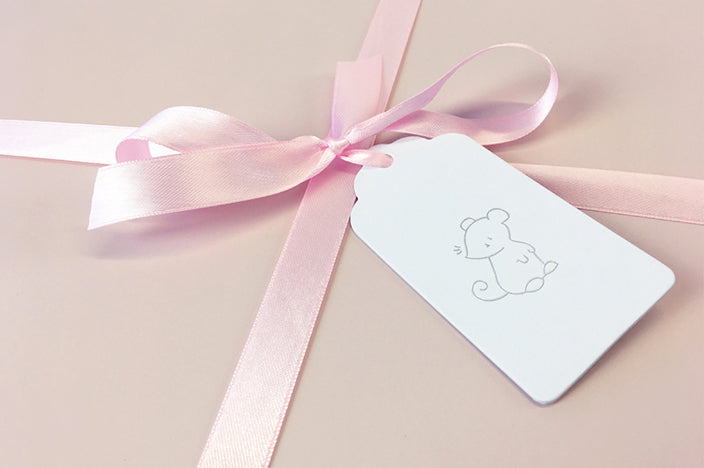 blush pink luxury gift box with satin ribbon and gift tag