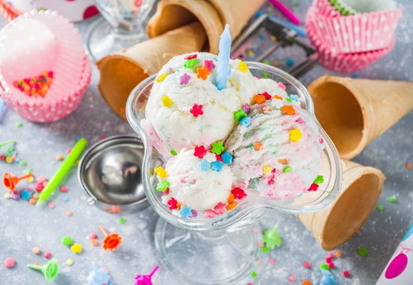 Birthday ice cream topped with sprinkles and candles