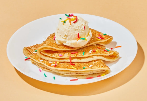 Crepes topped with ice cream and sprinkles