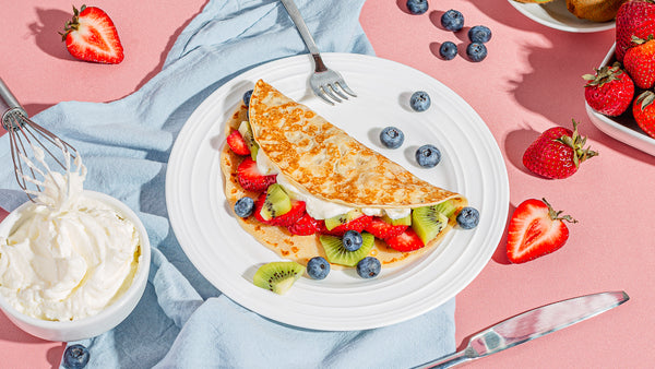 Whipped cream and fresh fruit crepes