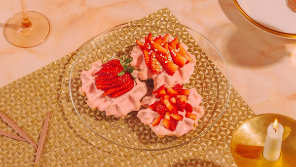 Belgian waffles dipped in pink chocolate and topped with strawberries