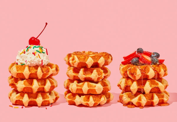 Stacks of Belgian waffles with various toppings