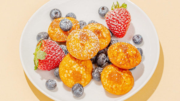 Belgian Boys Bite-Sized Pancakes topped with berries and powdered sugar