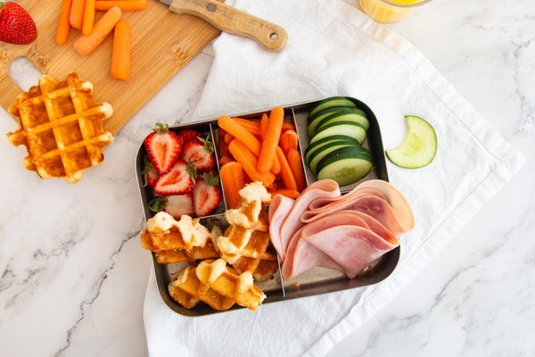 Lunch box with Belgian waffles, veggies, fruit and lunch meat