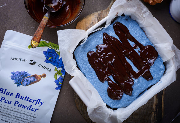 Melted chocolate glaze on blue matcha mint brownies