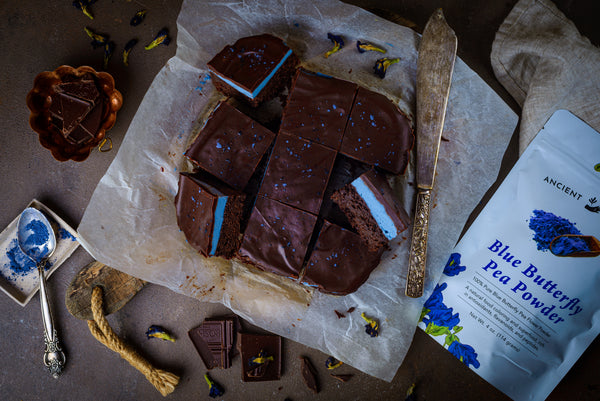 Blue Matcha Mint Brownies neatly sliced with butterfly pea flower powder nearby