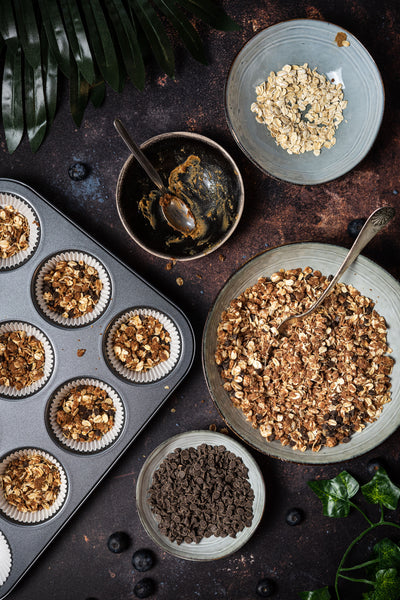 Muffin molds partially filled with a crunchy base