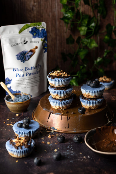 Butterfly pea flower frozen yogurt cups stacked on a table