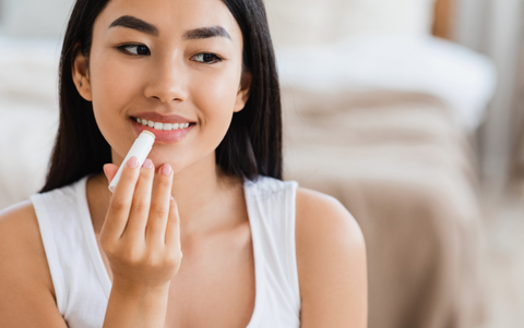 woman applying vegan lip balm - J&L Naturals