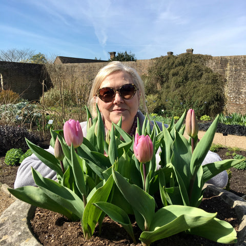 Photo of Angela Crosskey with tulip flowers in foreground 
