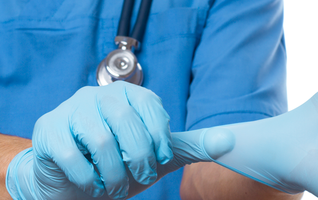 A nurse wearing disposable medical gloves.