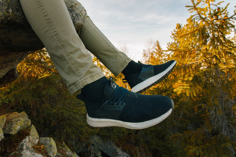 Man-breathable-sneakers-hiking-rocks-forest