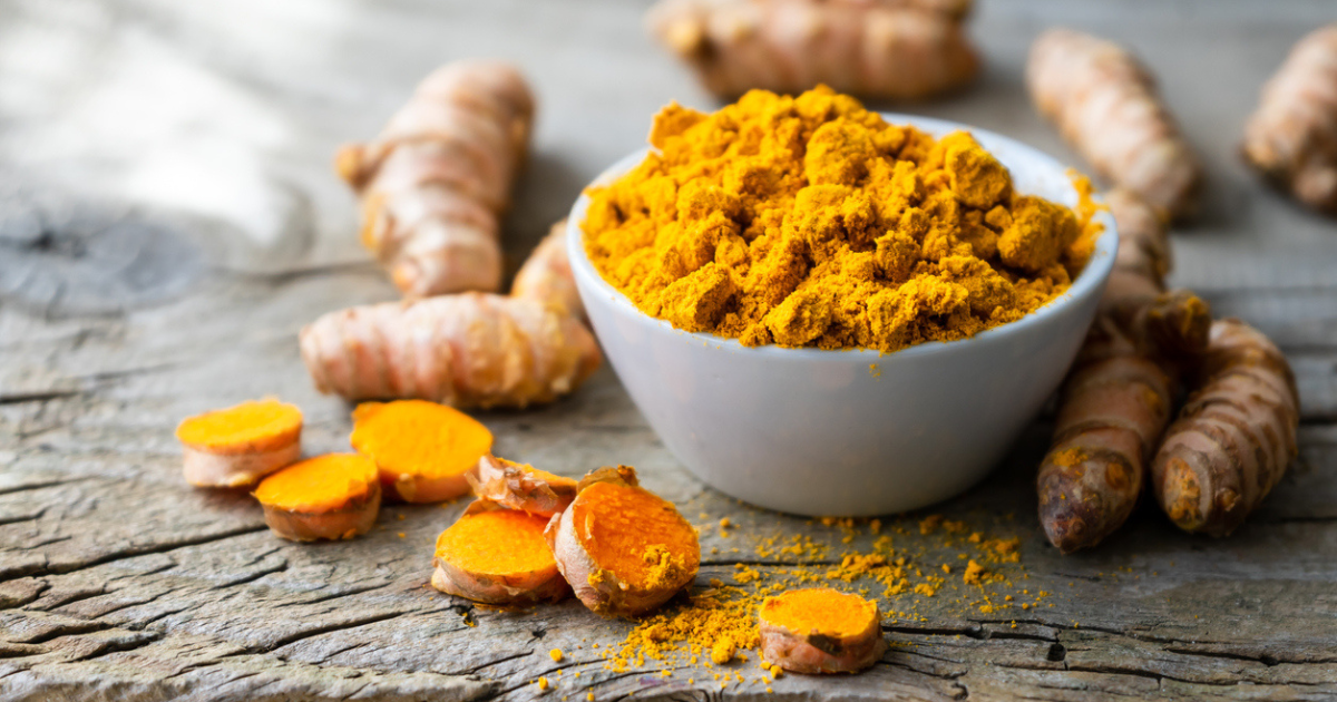 A bowl filled with ground tumeric powder.
